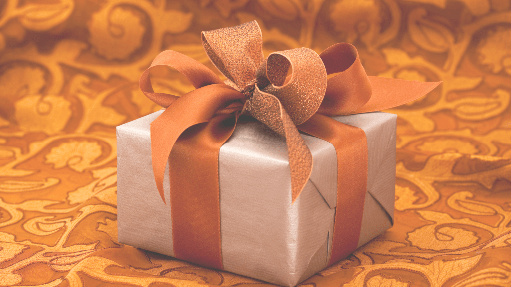 the-cost-of-loving-well-signified-by-a-gift-wrapped-in-gold-ribbon