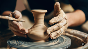 A potter molding a clay vase on a potter's wheel as a symbol of how God transforms us through our writing