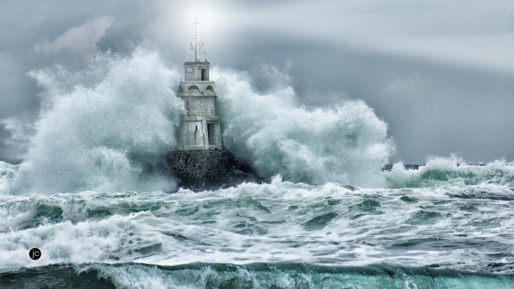 A white lighthouse standing securely on a rock foundation as the storm rages, symbolizing unshakable faith when you don't have the answers