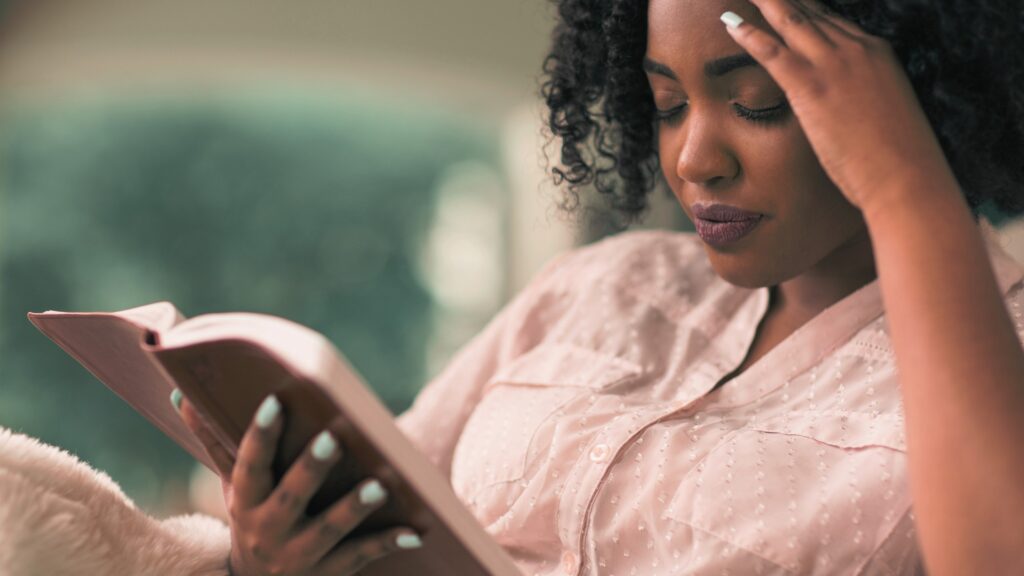 A woman enjoying some guilt-free Bible reading after realizing that daily Bible reading is not a requirement for Christian women