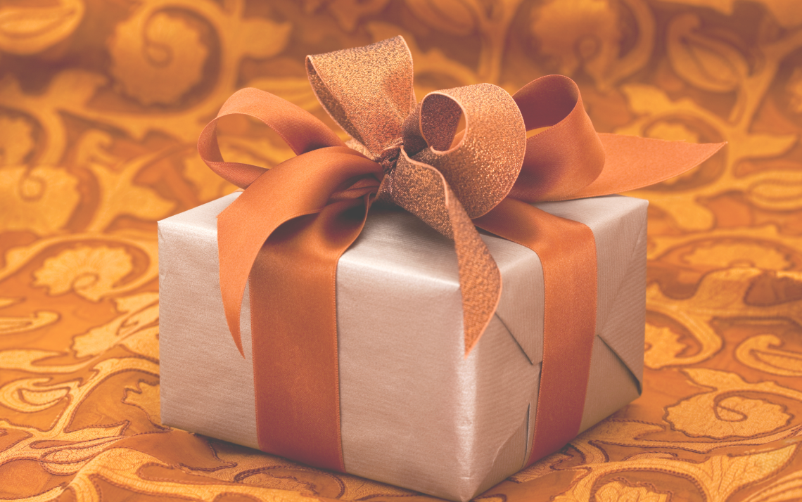 the-cost-of-loving-well-signified-by-a-gift-wrapped-in-gold-ribbon
