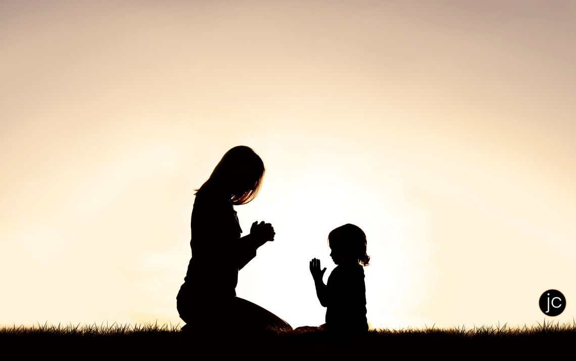 Silhouettes of a Christian mom and her young daughter kneeling in prayer - how to see God's answers to prayer